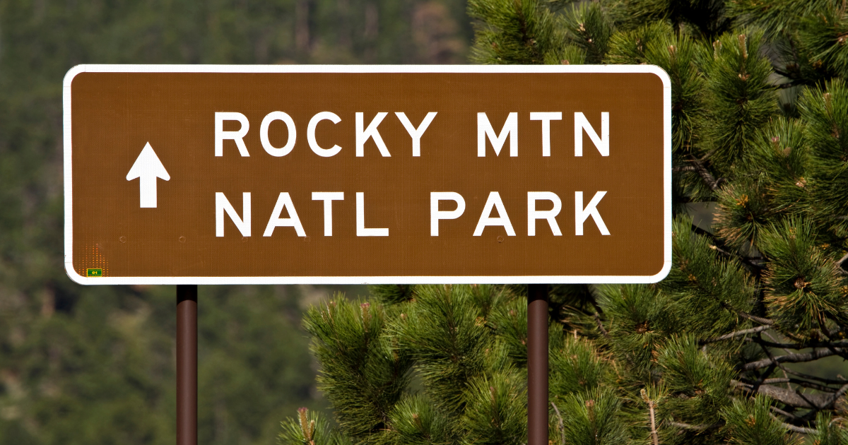 Brown and white road sign Rocky Mountain National Park