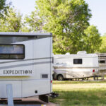 Many RVs are camping in a park