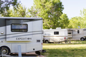 Many RVs are camping in a park